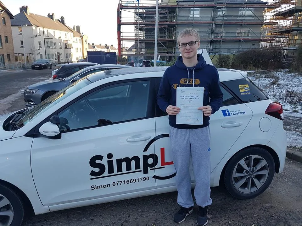 A learner celebrating a driving test pass